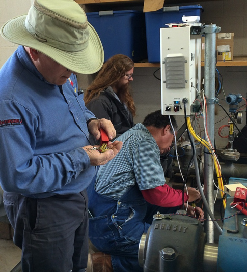 Tom Bowes, Doug Bates and Scott Wilfong work on installing the new hydro control system.